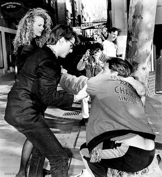 Tom Cruise and Nicole Kidman help out a photographer who fell over after walking backwards trying to get a picture of them.jpg