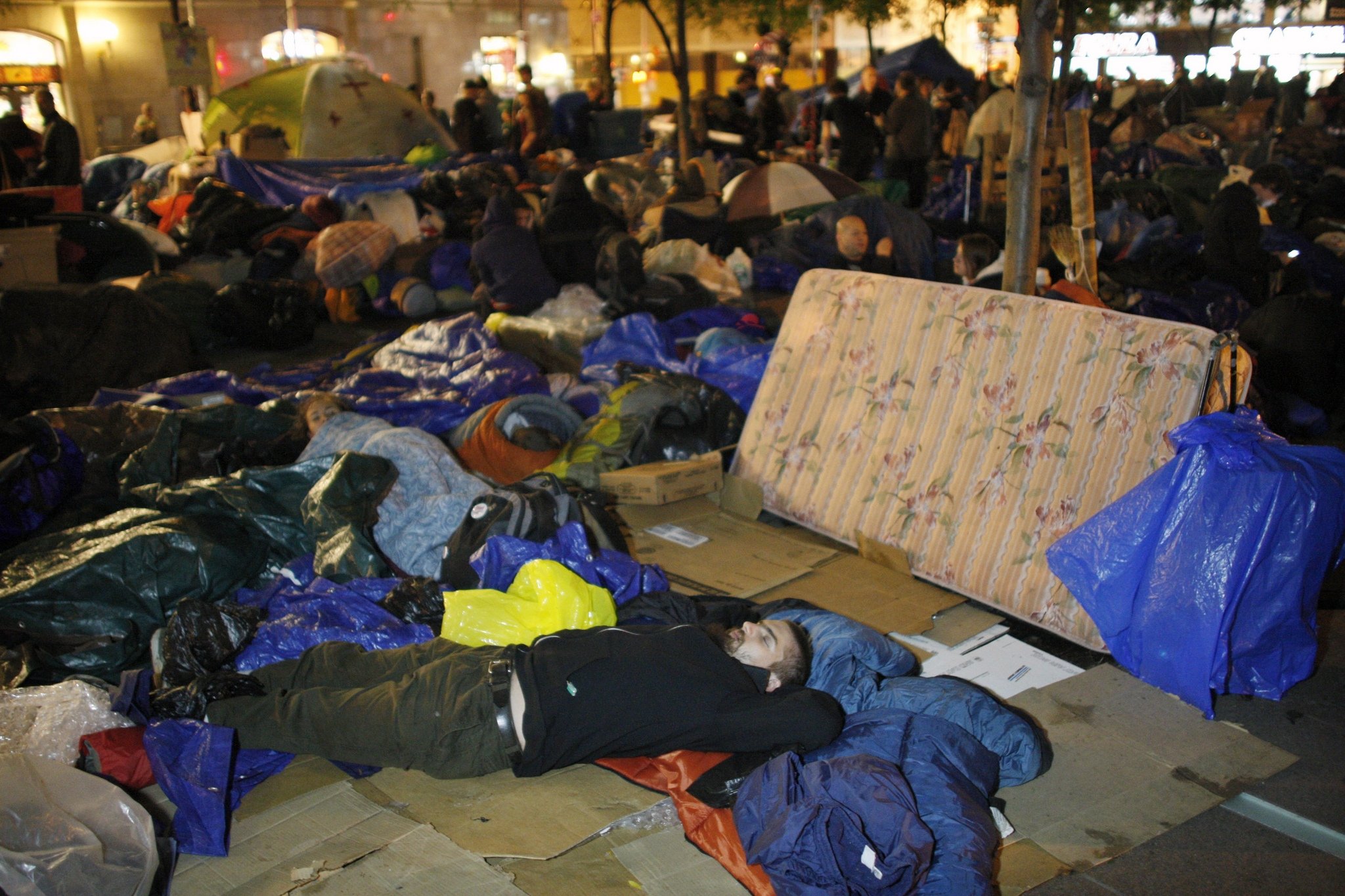 an-occupy-wall-street-protester-sleeps-in-zuccotti-park-near-wall-street-in-new-york-f2cbfc093f72b4f9.jpg