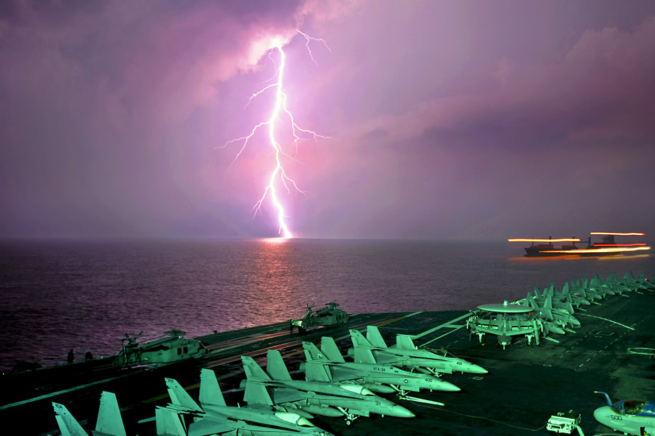 Lighting flashes as the aircraft carrier USS Abraham Lincoln transits in the Straight of Malacca, Oct. 8, 2010..jpg