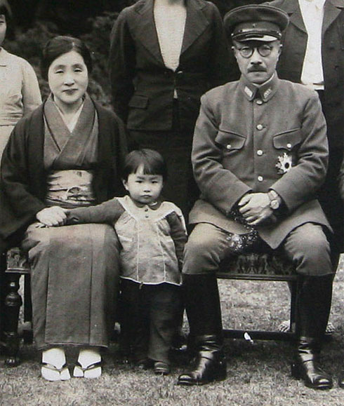 Prime Minister Hideki Tojo sits with his granddaughter Yuko, center, and his wife, Katsuko, in the garden of the prime minister's official residence in Tokyo.jpg